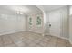 Bright dining room featuring tile floors, three windows, and a front door at 12867 Woodmere Close Dr, Windermere, FL 34786