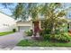 Charming home featuring a two-car garage, brick driveway, and mature landscaping at 12867 Woodmere Close Dr, Windermere, FL 34786