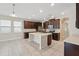Designer kitchen featuring dark wood cabinets, stainless appliances, and a large island at 12867 Woodmere Close Dr, Windermere, FL 34786