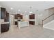 Modern kitchen with dark wood cabinets, stainless appliances, and a central island at 12867 Woodmere Close Dr, Windermere, FL 34786