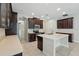 Well-lit kitchen featuring dark cabinetry and a center island with a sink and white countertop at 12867 Woodmere Close Dr, Windermere, FL 34786