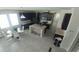 Open concept kitchen with dark cabinetry, stainless steel appliances, a center island with barstool seating, and an adjacent dining area at 12867 Woodmere Close Dr, Windermere, FL 34786