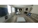 Open-concept living space with a modern kitchen, dining area, and comfortable living room with a large TV at 12867 Woodmere Close Dr, Windermere, FL 34786