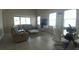 Spacious living room with large windows, modern furniture, and an open layout connecting to the dining area at 12867 Woodmere Close Dr, Windermere, FL 34786