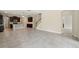 Expansive living area showcasing an open floor plan to the kitchen, tiled floors, and staircase at 12867 Woodmere Close Dr, Windermere, FL 34786