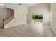 Vast open-plan living space with tile flooring, staircase, and sliding glass doors to yard at 12867 Woodmere Close Dr, Windermere, FL 34786