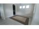 Bright living room featuring tile floors, neutral walls, and three windows letting in natural light at 12867 Woodmere Close Dr, Windermere, FL 34786