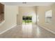 Spacious living room boasting tile floors, backyard views, and a high vaulted ceiling at 12867 Woodmere Close Dr, Windermere, FL 34786