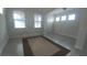 Inviting living room with large windows, tile floors, offering a bright and welcoming atmosphere at 12867 Woodmere Close Dr, Windermere, FL 34786