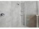 Close up of a tiled shower with glass door and chrome hardware at 12867 Woodmere Close Dr, Windermere, FL 34786