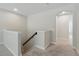 Carpeted staircase landing with a railing and an arched doorway leading to another room at 12867 Woodmere Close Dr, Windermere, FL 34786