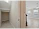 Open storage area or closet space off a hallway leading to a room with natural light at 12867 Woodmere Close Dr, Windermere, FL 34786
