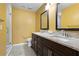 Bathroom featuring double sinks, granite countertops, dark wood cabinetry and walk in shower at 13427 Fairway Glen Dr # 103, Orlando, FL 32824