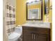 Bathroom with a dark vanity, granite countertop, framed mirror, and patterned shower curtain at 13427 Fairway Glen Dr # 103, Orlando, FL 32824