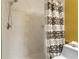 Bathroom shower with large, tiled surround and a patterned curtain at 13427 Fairway Glen Dr # 103, Orlando, FL 32824