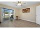 Bedroom with tile floors, ceiling fan, slider doors to patio and backyard views at 13427 Fairway Glen Dr # 103, Orlando, FL 32824