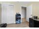 Bedroom or home office with a closet, shelving unit, and workout equipment at 13427 Fairway Glen Dr # 103, Orlando, FL 32824