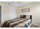 Bedroom with light walls, a ceiling fan, and a closet with sliding doors at 13427 Fairway Glen Dr # 103, Orlando, FL 32824