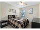 This bedroom features neutral walls, grey wood-style flooring, and a ceiling fan at 13427 Fairway Glen Dr # 103, Orlando, FL 32824