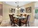 Dining room with a glass-top table, seating for six, and stylish overhead lighting at 13427 Fairway Glen Dr # 103, Orlando, FL 32824