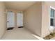 Condo entrance featuring two white doors with individual unit numbers and exterior lighting at 13427 Fairway Glen Dr # 103, Orlando, FL 32824