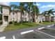 Exterior view of a two-story condo building in a tropical landscaped community at 13427 Fairway Glen Dr # 103, Orlando, FL 32824