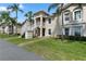 Inviting two-story condo building with lush landscaping and palm trees at 13427 Fairway Glen Dr # 103, Orlando, FL 32824