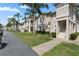Charming two-story condo building surrounded by green lawn and palm trees at 13427 Fairway Glen Dr # 103, Orlando, FL 32824