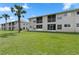Exterior view of the building showing well-manicured lawn and screened-in patios on the units at 13427 Fairway Glen Dr # 103, Orlando, FL 32824