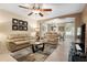 Inviting living room featuring tile floors, neutral walls, a ceiling fan, and ample seating at 13427 Fairway Glen Dr # 103, Orlando, FL 32824