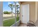 A screened patio overlooks a fenced lawn with palm trees and blue skies at 13427 Fairway Glen Dr # 103, Orlando, FL 32824