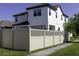A fenced-in backyard featuring a covered patio with ceiling fans for outdoor enjoyment at 15079 Guava Bay Dr, Winter Garden, FL 34787