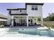 Stunning backyard showcasing a luxurious pool, covered patio, and well-manicured lawn at 15079 Guava Bay Dr, Winter Garden, FL 34787