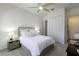 Bright bedroom features a ceiling fan, a large bed, and large windows with curtains at 15079 Guava Bay Dr, Winter Garden, FL 34787