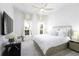 Bright bedroom features a ceiling fan and large windows with curtains at 15079 Guava Bay Dr, Winter Garden, FL 34787