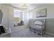 Bedroom with built-in shelves, a crib, and decor at 15079 Guava Bay Dr, Winter Garden, FL 34787