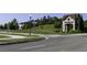 Well-maintained community entrance with manicured lawns and a charming stone welcome sign at 15079 Guava Bay Dr, Winter Garden, FL 34787