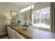 Elegant dining room with large windows, stylish lighting, and modern decor at 15079 Guava Bay Dr, Winter Garden, FL 34787