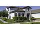 Attractive home with a stone facade, manicured lawn, mature landscaping, and located on the corner at 15079 Guava Bay Dr, Winter Garden, FL 34787