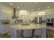 Stylish kitchen with stainless steel appliances, a center island with seating, and ample counter space at 15079 Guava Bay Dr, Winter Garden, FL 34787