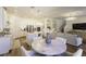 Bright, open-concept living area featuring a kitchen with white cabinetry, marble table, and comfortable seating at 15079 Guava Bay Dr, Winter Garden, FL 34787