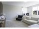 Cozy living room with carpet, chair, sofa, and natural light from window at 15079 Guava Bay Dr, Winter Garden, FL 34787