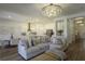 Open-concept living area with a comfortable sofa, kitchen island, and modern finishes at 15079 Guava Bay Dr, Winter Garden, FL 34787
