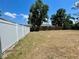 Expansive backyard is enclosed by a combination of wood and white vinyl fencing at 1561 Cypress Woods Cir, St Cloud, FL 34772