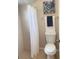 Bathroom features a toilet, and a white shower curtain at 1561 Cypress Woods Cir, St Cloud, FL 34772