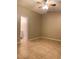 Empty bedroom with tile flooring, ceiling fan with light, and doorway to a second bathroom at 1561 Cypress Woods Cir, St Cloud, FL 34772