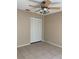 Empty bedroom with tile flooring, ceiling fan with light, and bi-fold closet doors at 1561 Cypress Woods Cir, St Cloud, FL 34772