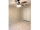 Empty bedroom with tile flooring, ceiling fan with light, and bi-fold closet doors at 1561 Cypress Woods Cir, St Cloud, FL 34772