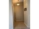 Inviting entryway with neutral tones, tile flooring, decorative vase, and a welcoming 'Home' sign at 1561 Cypress Woods Cir, St Cloud, FL 34772