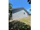 Exterior side view of home with shrubs and a small window at 1561 Cypress Woods Cir, St Cloud, FL 34772